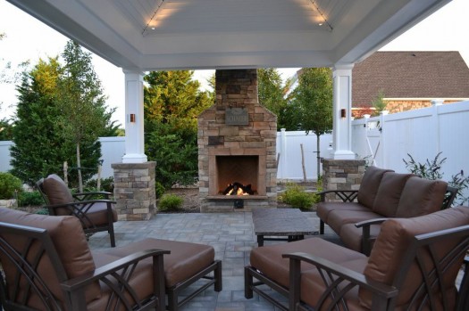Outdoor Fireplace: At the edge of a patio, beside a lovely shingle-roof gazebo/pergola, this fireplace not only offers warmth in autumn and winter months but it creates the perfect ambience for conversation.