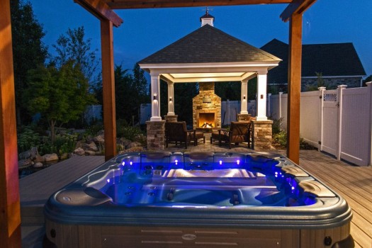 Spa and Outdoor Fireplace: A portable spa set under a pergola — and next to an outdoor pavilion — is the perfect night-time setting.