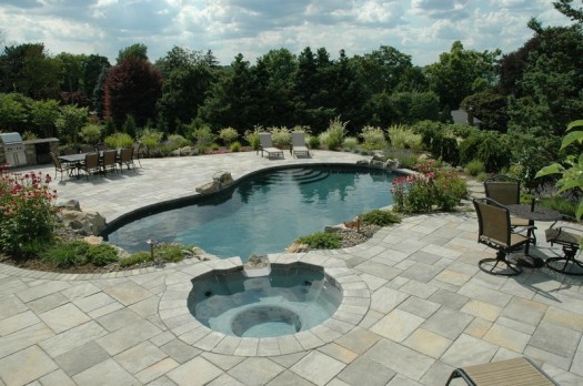 Stepping Stone Path: New stepping stone path beside the pool provides a swath of natural charm within the expansive patio areas; swim-out steps were also added to the pool.