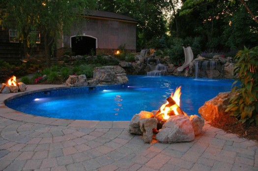 Natural Gas Campfires: If one campfire is good, two or more is even better. Note how outdoor breezes blow across the natural gas flames to create warm puffs of air and how the soft flickering light dances across the pool.