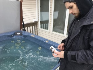 Best Hot Tubs' Windham Service Manager, Hunter Armstrong, checking water quality's pH