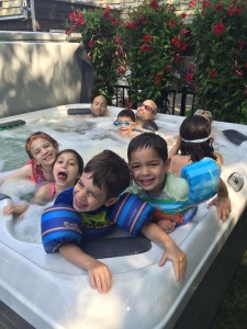 These Best Hot Tubs clients purchased an X7 model from our showroom. It’s Bullfrog Spas’ price-friendly mode. Yet it was big enough for their extended family. They chose a Platinum interior and Driftwood exterior and as for a positive review: the photo they sent us to share speaks for itself. While the adults lean back to enjoy Bullfrog’s famous jet massage seats, the kids are definitely in it for the fun.