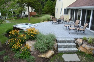 Positioning a spa partially against a patio or deck permits easy access to spa’s plumbing equipment. 