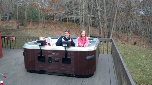 This photo of a mom and her two kids pretty much says it all sitting in their just installed Bullfrog Spa.