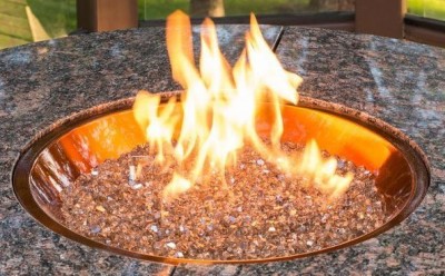 Glass Fire Gems: If you have a natural gas fire pit/table, you can change the color of the fire gems as well. The gems come in many shapes and sizes and are easily changed to suit the season. For Fall, how about a copper glass gem (pictured here) to give an amber appearance. Photo: Outdoor GreatRoom Company