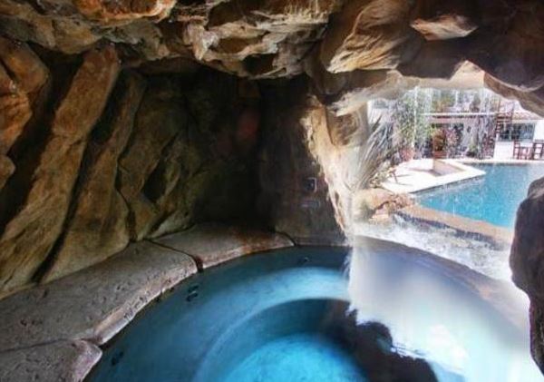 Singer Alecia Beth Moore, also known as Pink, has her hot tub set inside a grotto that looks out through a waterfall at the pool. Nice, really nice, even if it isn’t pink.