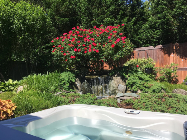 It's nice when in your spa to have an attractive focal point to enjoy — in this case a small water feature and beautiful flowering shrub. Best Hot Tubs works with a lot of firms in the area who can help provide the perfect peaceful setting you're looking for.
