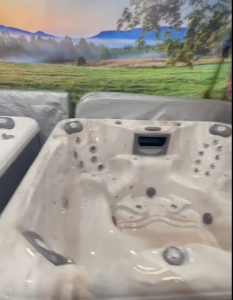Close up of interiors of two Aspen Spas with scenic landscape mural behind it